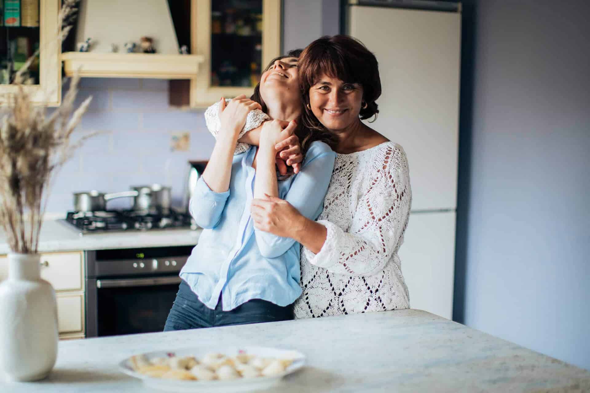 Mother and daughter cuddling and being happy